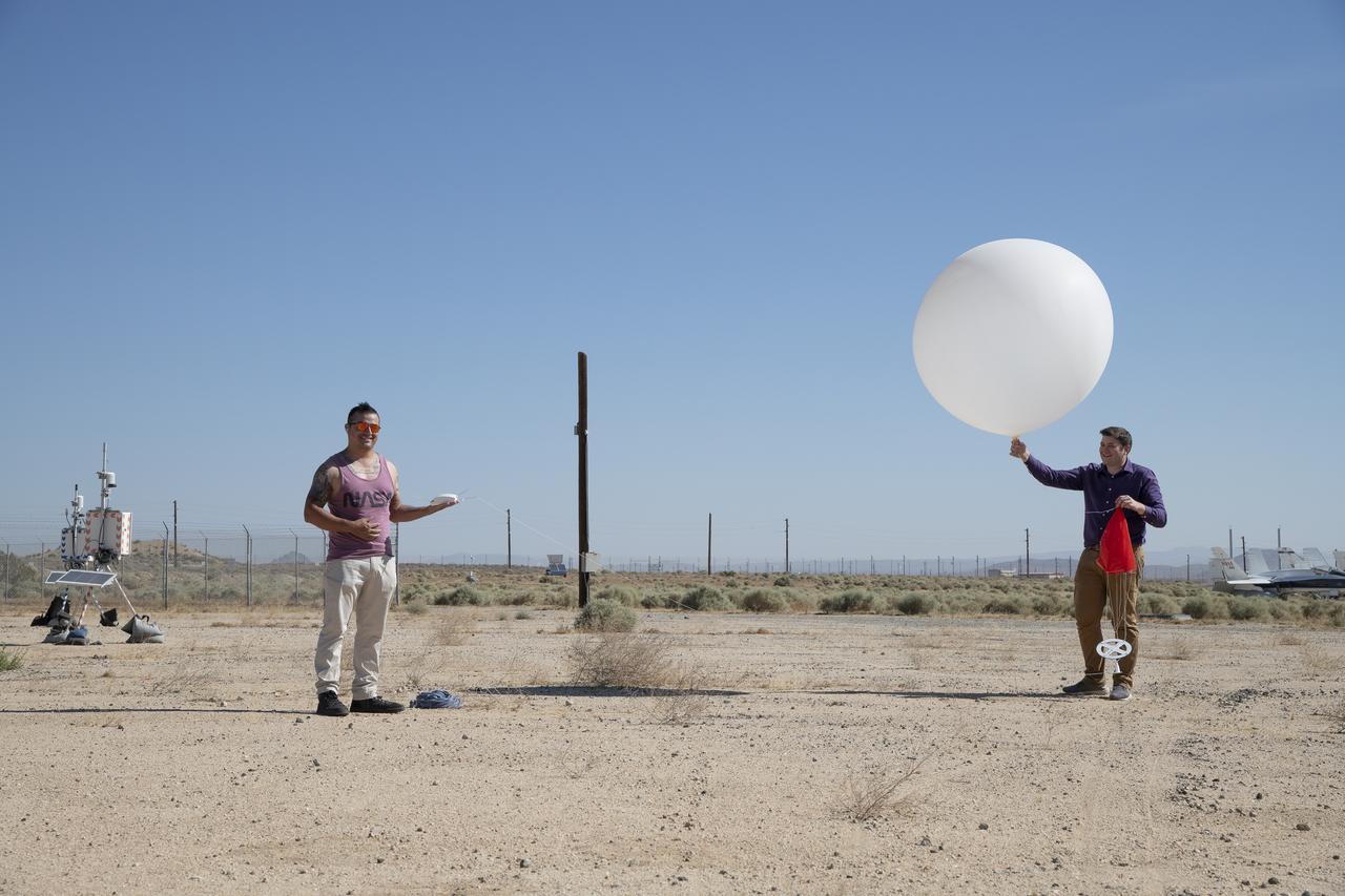 Rocky Garcia and Wesley James prepare a weather balloon to collect wind data for the Advanced Exploration of Reliable Operation at Low Altitudes: Meteorology, Simulation and Technology campaign. The weather study was at NASA’s Armstrong Flight Research Center in Edwards, California. The focus was to study wind from the ground to 2,000 feet to provide data to assist future drones to safely land on rooftop hubs called vertiports and to potentially improve weather prediction.