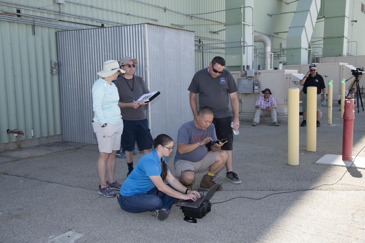 Tyler Willhite, sitting, and Derek Abramson and Justin Link, prepare for an Alta-X aircraft flight. Behind them are Jennifer Fowler, from left and Grady Kock. The Alta-X flight was part of the Advanced Exploration of Reliable Operation at Low Altitudes: Meteorology, Simulation and Technology campaign. The campaign was at NASA Armstrong to study wind from the ground to 2,000 feet to provide data to assist future drones to safely land on rooftop hubs called vertiports and to potentially improve weather prediction.