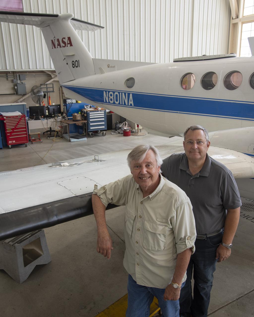 Cal Poly San Luis Obispo professors Russ Westphal, left, and Aaron Drake posed next to NASA Armstrong Flight Research Center’s Beechcraft Beech 200 Super King Air aircraft.   On the King Air’s wing is the Boundary Layer Data System (BLDS), a sensor developed by Cal Poly and Northrop Grumman. BLDS was flown at NASA Armstrong as a step towards creating a process allowing universities, small businesses and other interested parties to quickly test flight technologies.