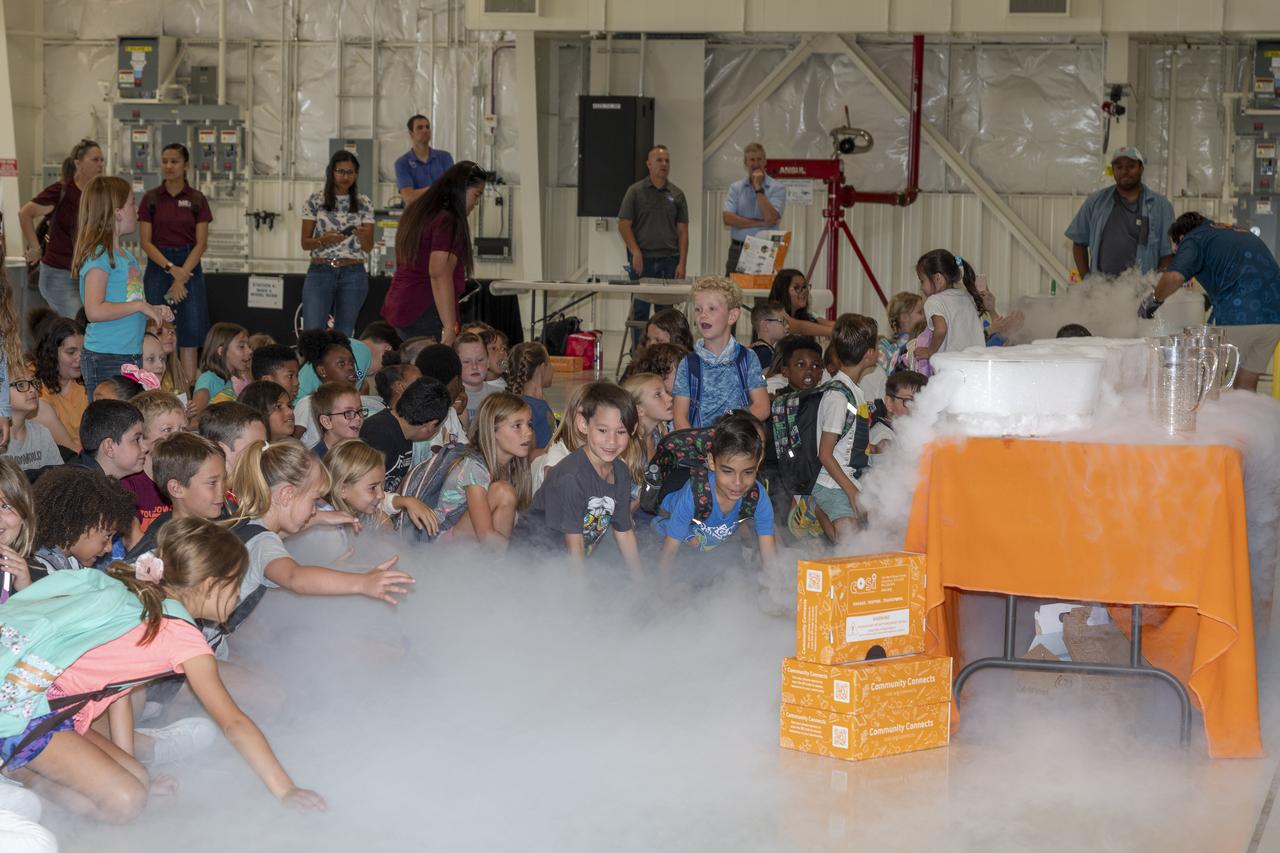 Students are wrapped in a cloud from a demonstration by NASA’s California Office of STEM Engagement event with Center of Science and Industry at NASA’s Armstrong Flight Research Center in Edwards, California.