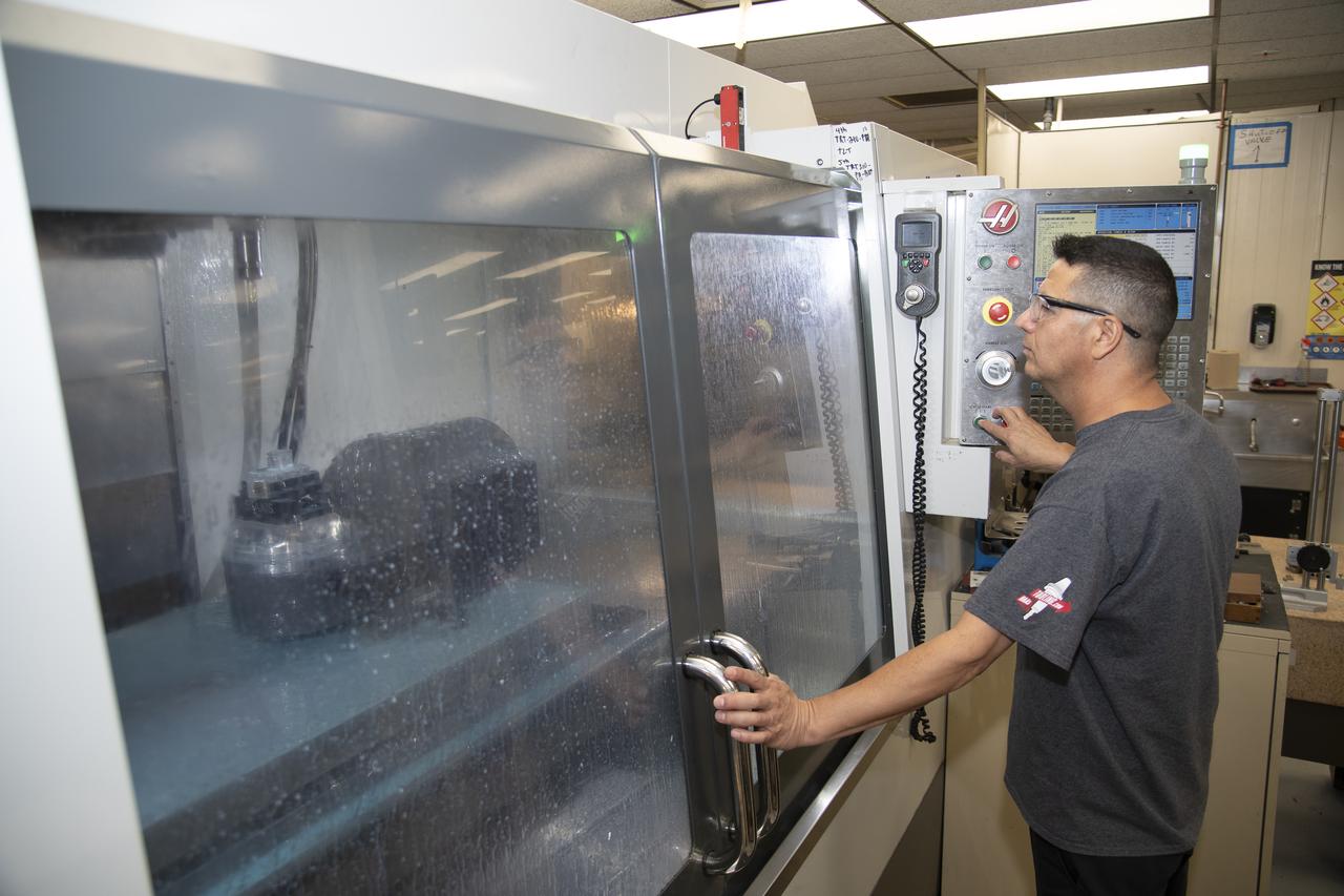 Jose Vasquez uses a machine to cut, rotate and turn a block of aluminum to make a forward wing strut fastener for a 10-foot model of the Transonic Truss-Braced Wing at NASA’s Armstrong Flight Research Center, in Edwards, California. The aircraft concept involves a wing braced on an aircraft using diagonal struts that also add lift and could result in significantly improved aerodynamics.