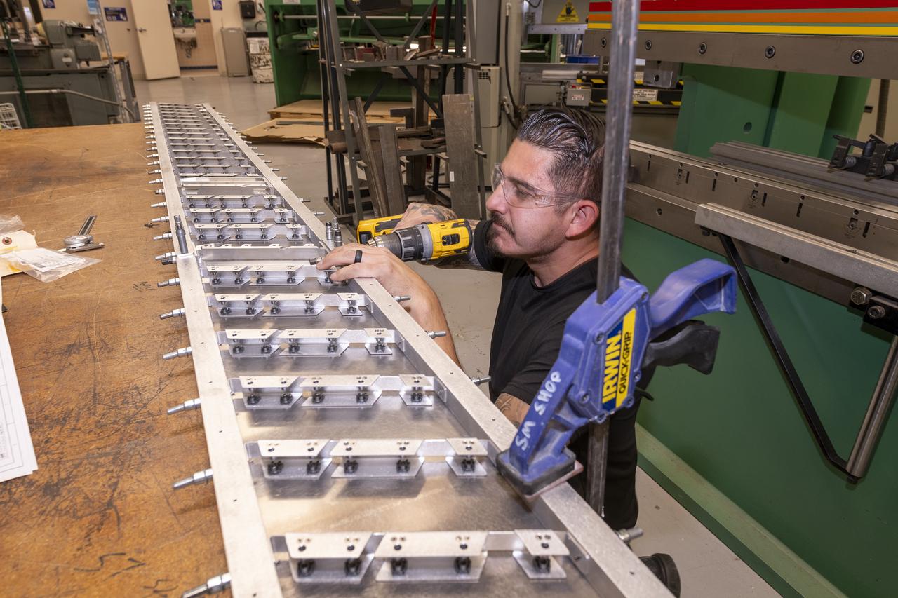 Matthew Sanchez assembles wing ribs to the 10-foot model of the Transonic Truss-Braced Wing at NASA’s Armstrong Flight Research Center, in Edwards, California. The aircraft concept involves a wing braced on an aircraft using diagonal struts that also add lift and could result in significantly improved aerodynamics.