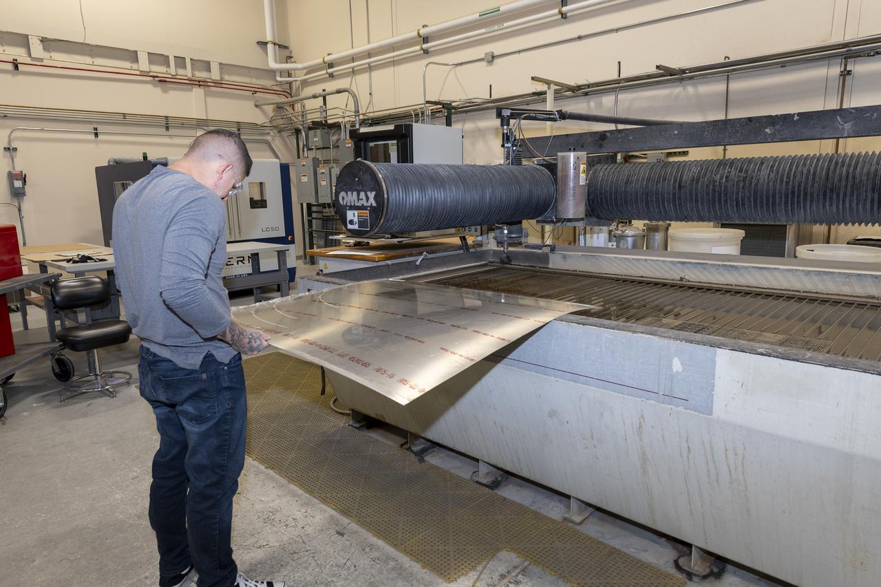 Matthew Sanchez prepares a sheet of aluminum that will be cut into the outer layer of the strut for the 10-foot model of the Transonic Truss-Braced Wing at NASA’s Armstrong Flight Research Center, in Edwards, California. The aircraft concept involves a wing braced on an aircraft using diagonal struts that also add lift and could result in significantly improved aerodynamics.