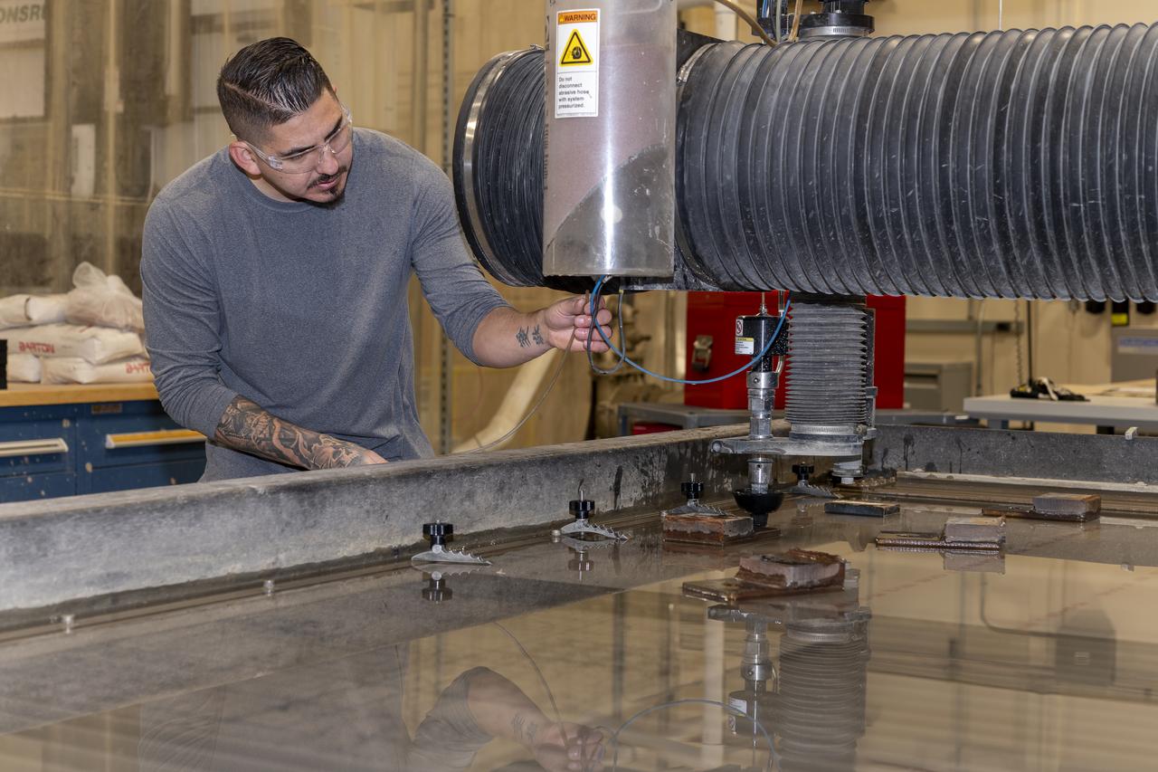 Matthew Sanchez uses a water jet to cut aluminum for the outer layer of the strut for the 10-foot model of the Transonic Truss-Braced Wing at NASA’s Armstrong Flight Research Center, in Edwards, California. The aircraft concept involves a wing braced on an aircraft using diagonal struts that also add lift and could result in significantly improved aerodynamics.