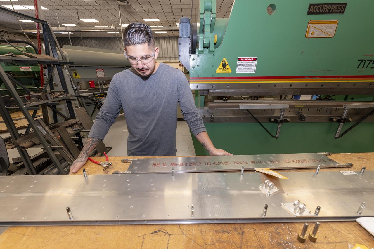 Matthew Sanchez places the strut and the wing side-by-side before assembling them for a check to ensure they fit together as intended for a 10-foot model of the Transonic Truss-Braced Wing at NASA’s Armstrong Flight Research Center, in Edwards, California. The aircraft concept involves a wing braced on an aircraft using diagonal struts that also add lift and could result in significantly improved aerodynamics.