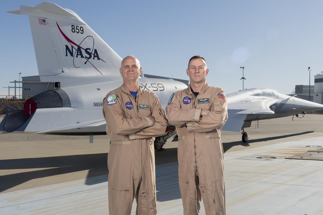 NASA test pilots Nils Larson (left) and Jim “Clue” Less (right) pose with the newly-painted X-59 as it sits on the ramp at Lockheed Martin Skunk Works in Palmdale, California. The X-59 is the centerpiece of NASA’s Quesst mission, which seeks to solve one of the major barriers to supersonic flight over land, currently banned in the United States, by making sonic booms quieter.