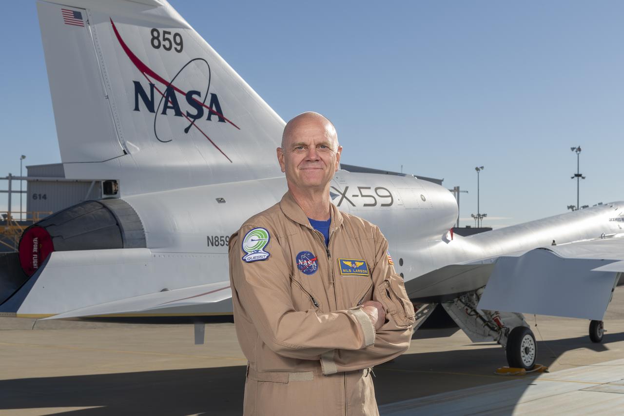 NASA test pilot Nils Larson poses with the newly-painted X-59 as it sits on the ramp at Lockheed Martin Skunk Works in Palmdale, California. The X-59 is the centerpiece of NASA’s Quesst mission, which seeks to solve one of the major barriers to supersonic flight over land, currently banned in the United States, by making sonic booms quieter.