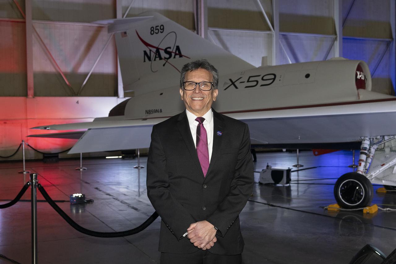NASA’s structures lead for the X-59, Dr. Walt Silva, poses in front of the agency’s X-59 quiet supersonic research aircraft at a January 12, 2024 event at Lockheed Martin Skunk Works in Palmdale, California. The X-59 is the centerpiece of NASA’s Quesst mission, which seeks to solve one of the major barriers to supersonic flight over land, currently banned in the United States, by making sonic booms quieter.