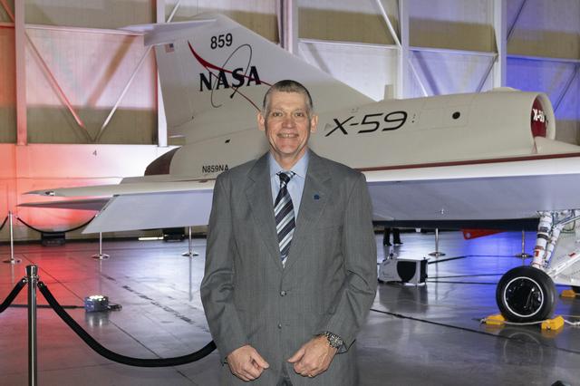 NASA Engineer Poses in Front of Unveiled X-59