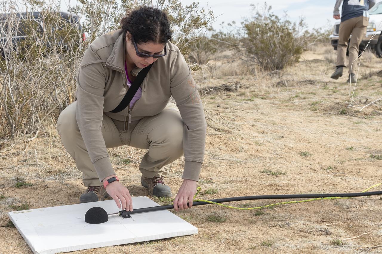 Dr. Alexandra Loubeau, one of the technical co-leads for sonic boom community testing for the Quesst mission, sets out a microphone in the California desert. . The Quesst mission recently completed testing of operations and equipment to be used in recording the sonic thumps of the X-59. The testing was the third phase of Carpet Determination in Entirety Measurements flights, called CarpetDIEM for short. An F-15 and an F-18 from NASA’s Armstrong Flight Research Center created sonic booms, both loud and soft, to verify the operations of ground recording systems spread out across 30 miles of open desert.