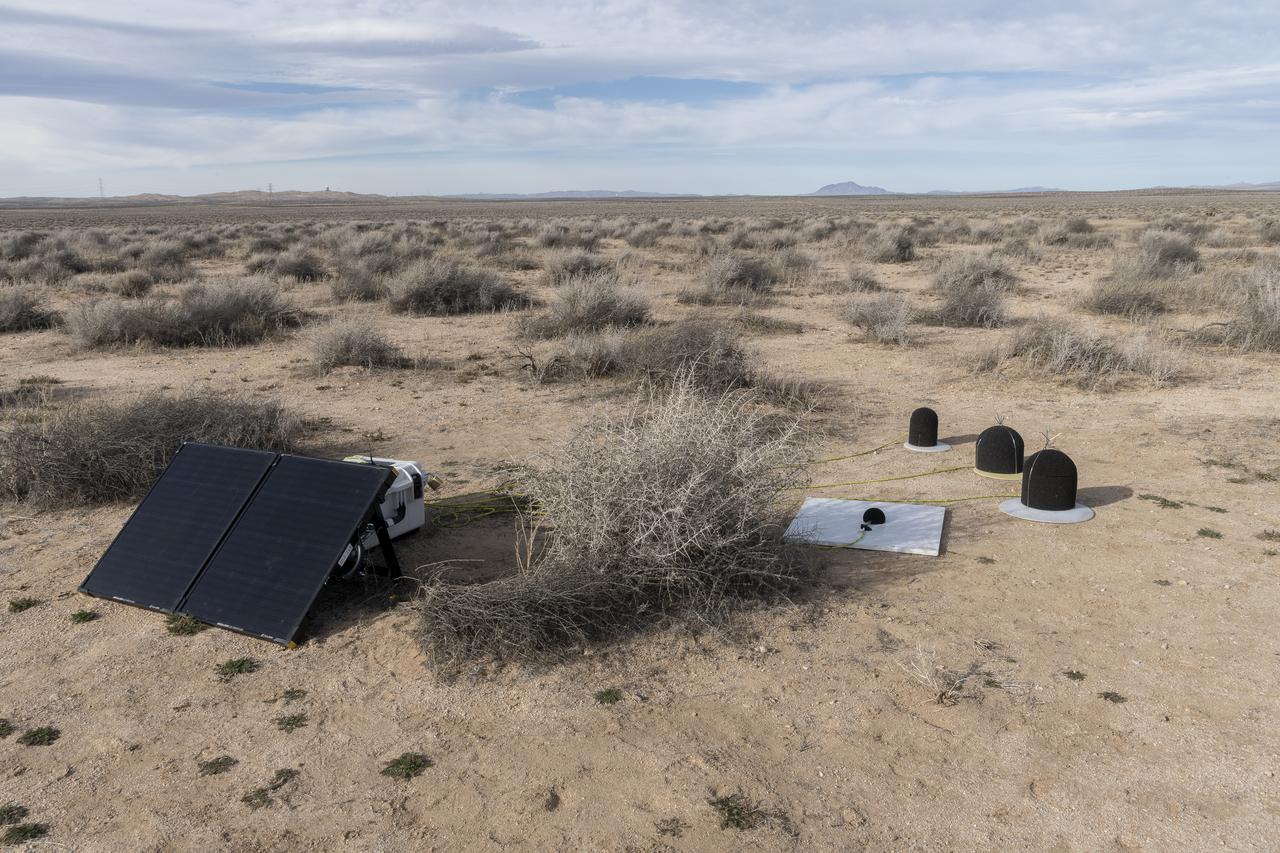 The Quesst mission recently completed testing of operations and equipment to be used in recording the sonic thumps of the X-59. Shown is one of 10 ground recording stations set up along a 30-mile stretch of desert to record sonic booms during the third phase of the of CarpetDIEM, Carpet Determination in Entirety Measurements flights. An F-15 and an F-18 from NASA’s Armstrong Flight Research Center created sonic booms, both loud and soft, to verify the operations of ground recording systems.