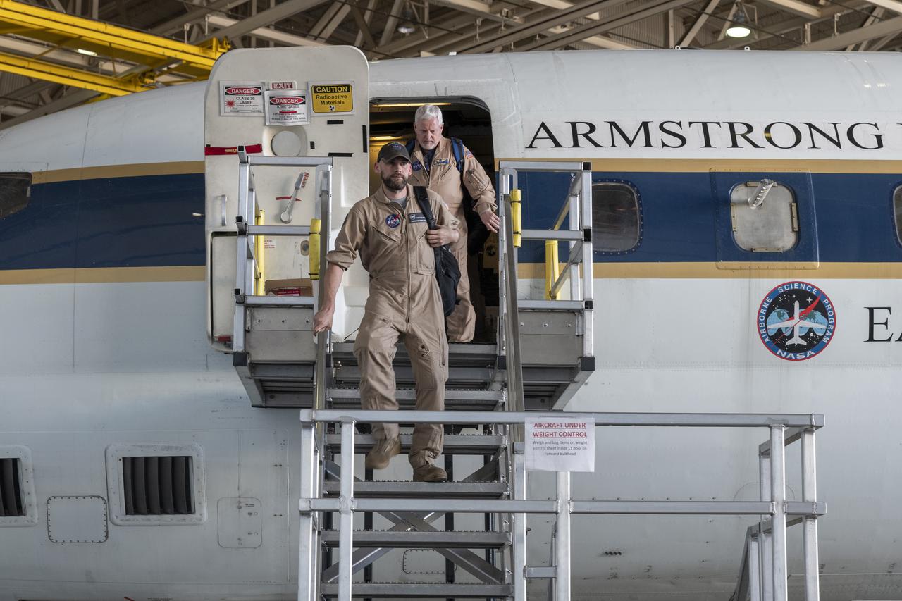 Kelly Jellison, avionics lead, and Tim Sandon, flight engineer, exit the DC-8 aircraft cabin and are welcomed with applause from a supportive team after the DC-8 aircraft and crew return to NASA’s Armstrong Flight Research Center Building 703 in Palmdale, California, on April 1, 2024, following the aircraft’s final mission in support of the Airborne and Satellite Investigation of Asian Air Quality (ASIA-AQ).