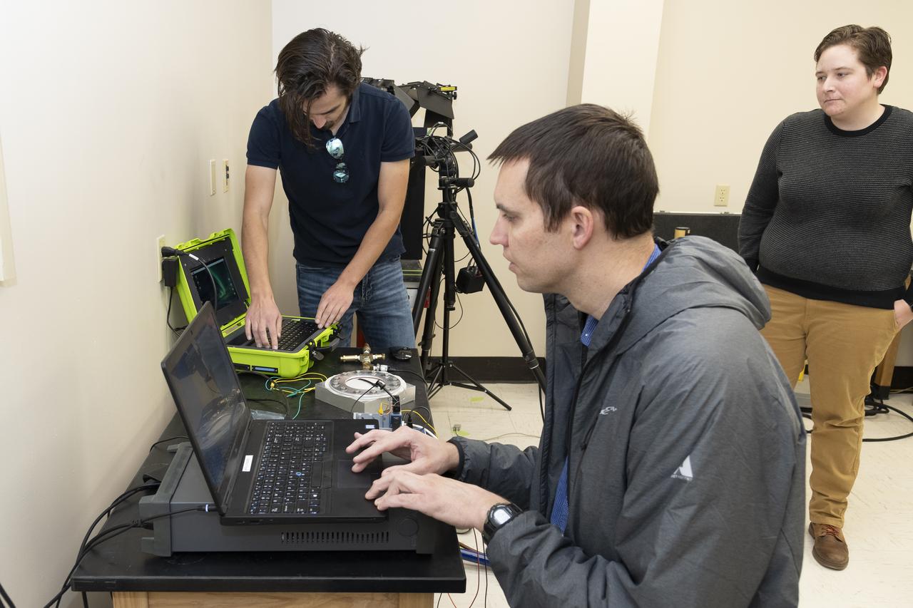 Coby Asselin, from left, Adam Curry, and L. J. Hantsche set up the data acquisition systems used during testing of a senor to determine parachute canopy material strength at NASA’s Armstrong Flight Research Center in Edwards, California. The sensor tests seek to quantify the limits of the material to improve computer models and make more reliable supersonic parachutes.