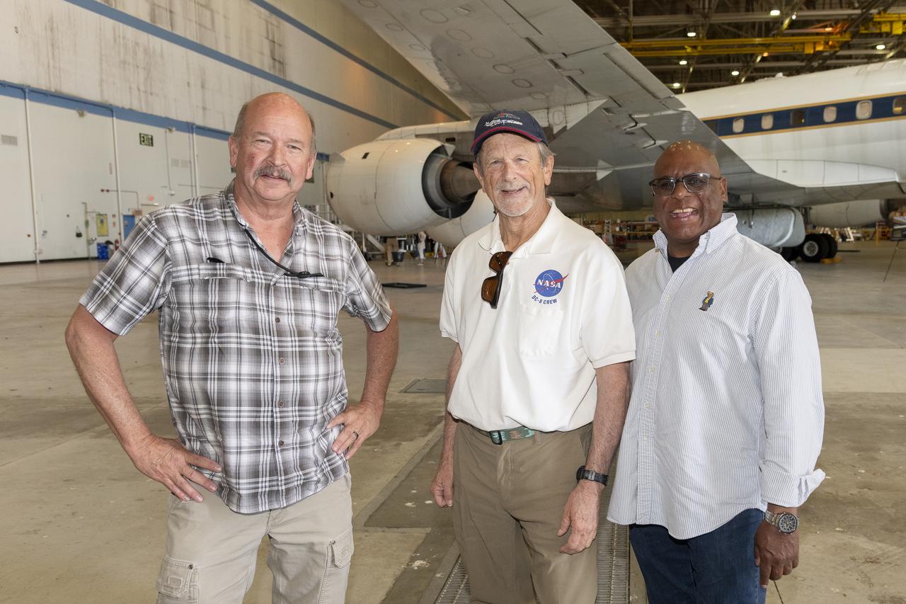 Rocky Radcliff, Kevin Hall, and Herman “Chico” Rijfkogel stand in front of NASA’s DC-8 aircraft at the agency’s Armstrong Flight Research Center Building 703 in Palmdale, California. On May 2, 2024, NASA personnel, friends, and family celebrated the DC-8 staff, aircraft, and science campaigns.