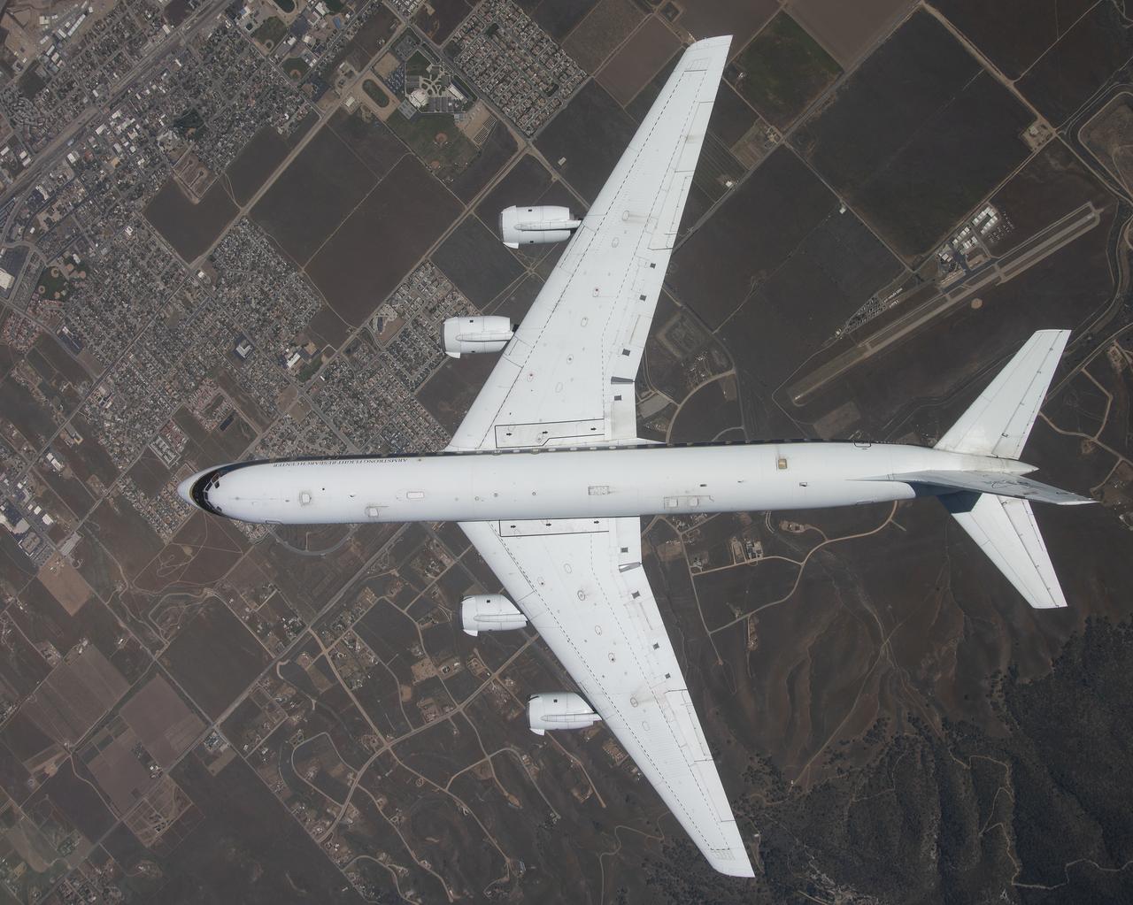 The DC-8 is shown overhead during its final flight from NASA’s Armstrong Flight Research Center Building 703 in Palmdale, California, before it retires to Idaho State University in Pocatello, Idaho. The DC-8 will provide real-world experience to train future aircraft technicians at the college’s Aircraft Maintenance Technology Program.