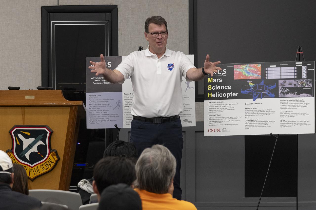 Brad Flick, center director at NASA’s Armstrong Flight Research Center in Edwards, California, talks to students from California State University, Northridge, California. As part of the university’s Autonomy Research Center for science, technology, engineering, entrepreneurship, arts, humanities, and mathematics, the students displayed posters and answered questions about their technologies May 23 at the Air Force Test Pilot School auditorium on Edwards Air Force Base, California.