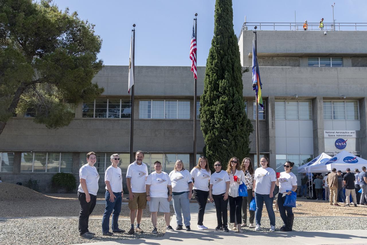 Members of the Sexuality and Gender Alliance Employee Resource Group at NASA’s Armstrong Flight Research Center in Edwards, California, pose for photo in front of the raised Progress Pride Flag at a flag-raising ceremony in recognition and celebration of LGBTQI+ Pride Month, Tuesday, June 4, 2024, at the center.