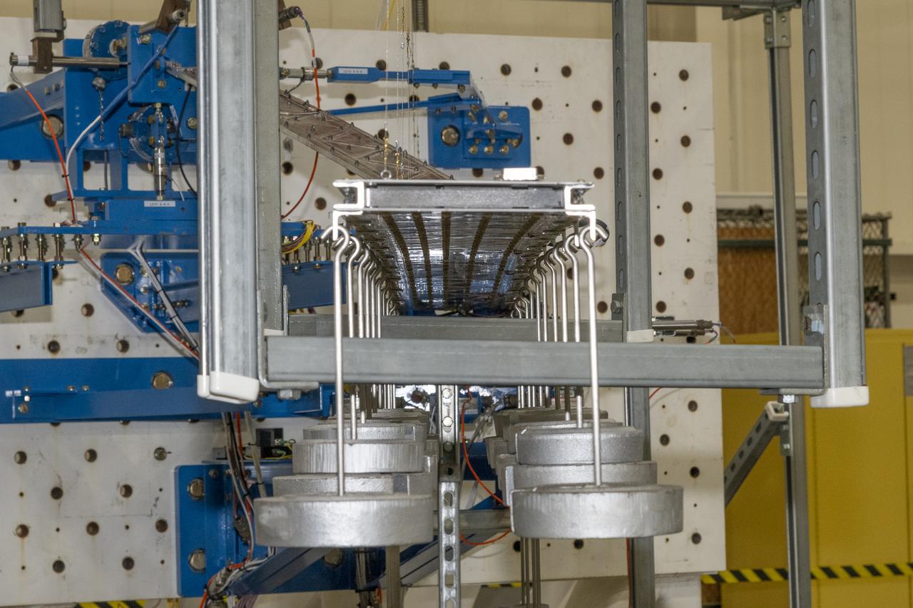 Researchers test a 10-foot Mock Truss-Braced Wing at NASA’s Armstrong Flight Research Center in Edwards, California. Weights are hung from the wing to apply stress used to determine its limits. The aircraft concept involves a wing braced on an aircraft using diagonal struts that also add lift and could result in significantly improved aerodynamics.