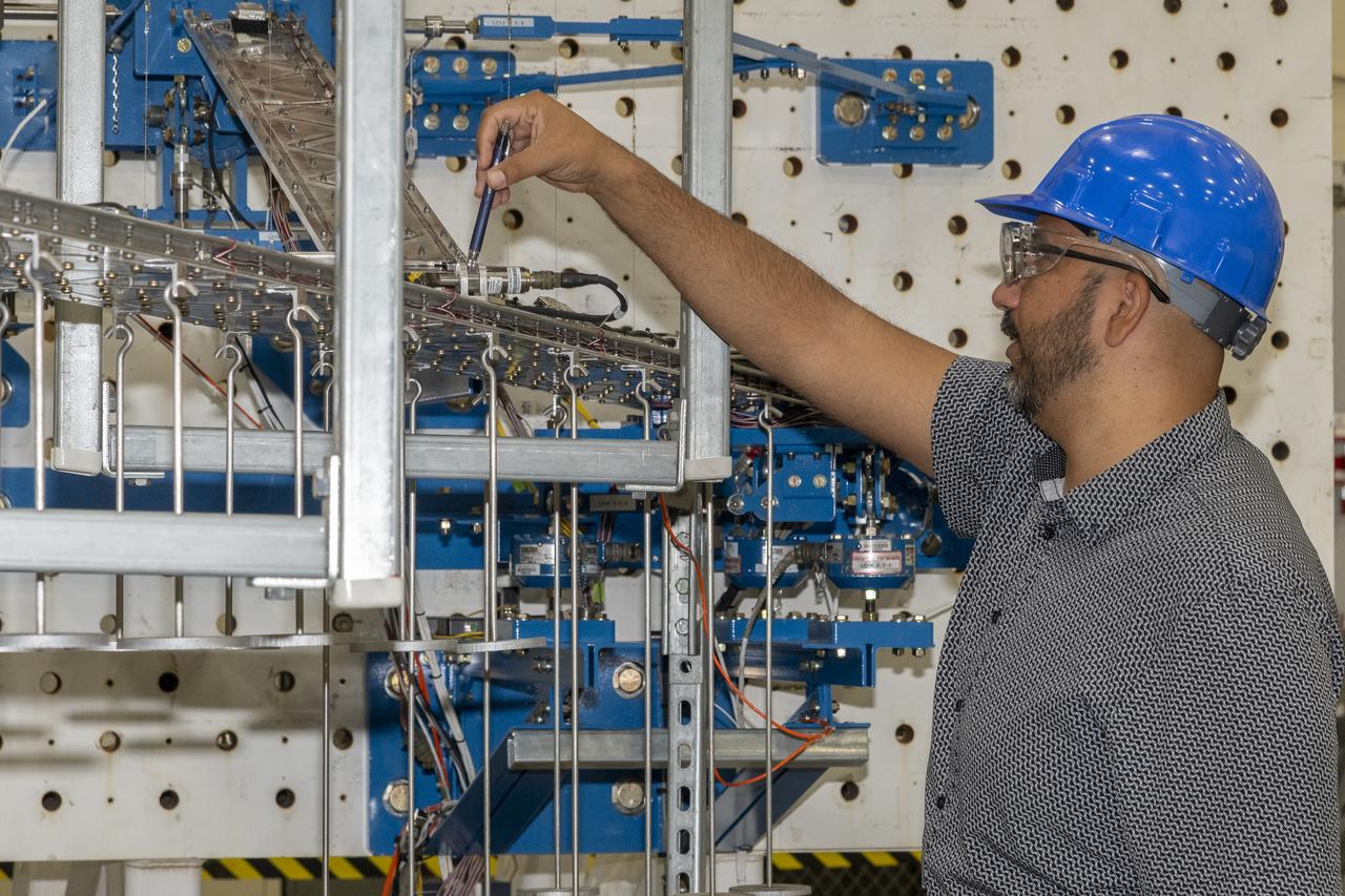 Researchers test a 10-foot Mock Truss-Braced Wing at NASA’s Armstrong Flight Research Center in Edwards, California. Frank Pena, test director, checks the mock wing. The aircraft concept involves a wing braced on an aircraft using diagonal struts that also add lift and could result in significantly improved aerodynamics.