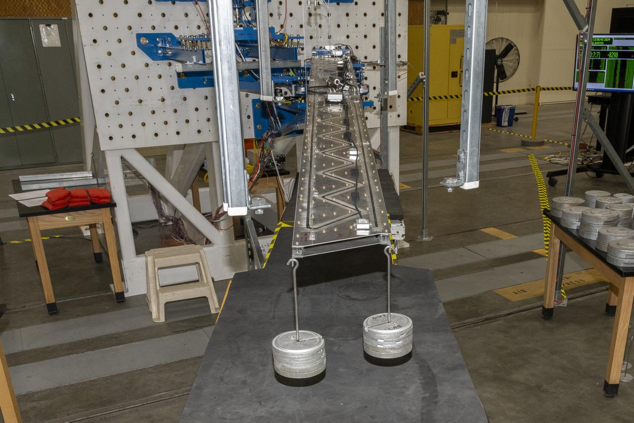 Researchers test a 10-foot Mock Truss-Braced Wing at NASA’s Armstrong Flight Research Center in Edwards, California. Weights are added to the wingtip to apply stress used to determine its limits. The aircraft concept involves a wing braced on an aircraft using diagonal struts that also add lift and could result in significantly improved aerodynamics.