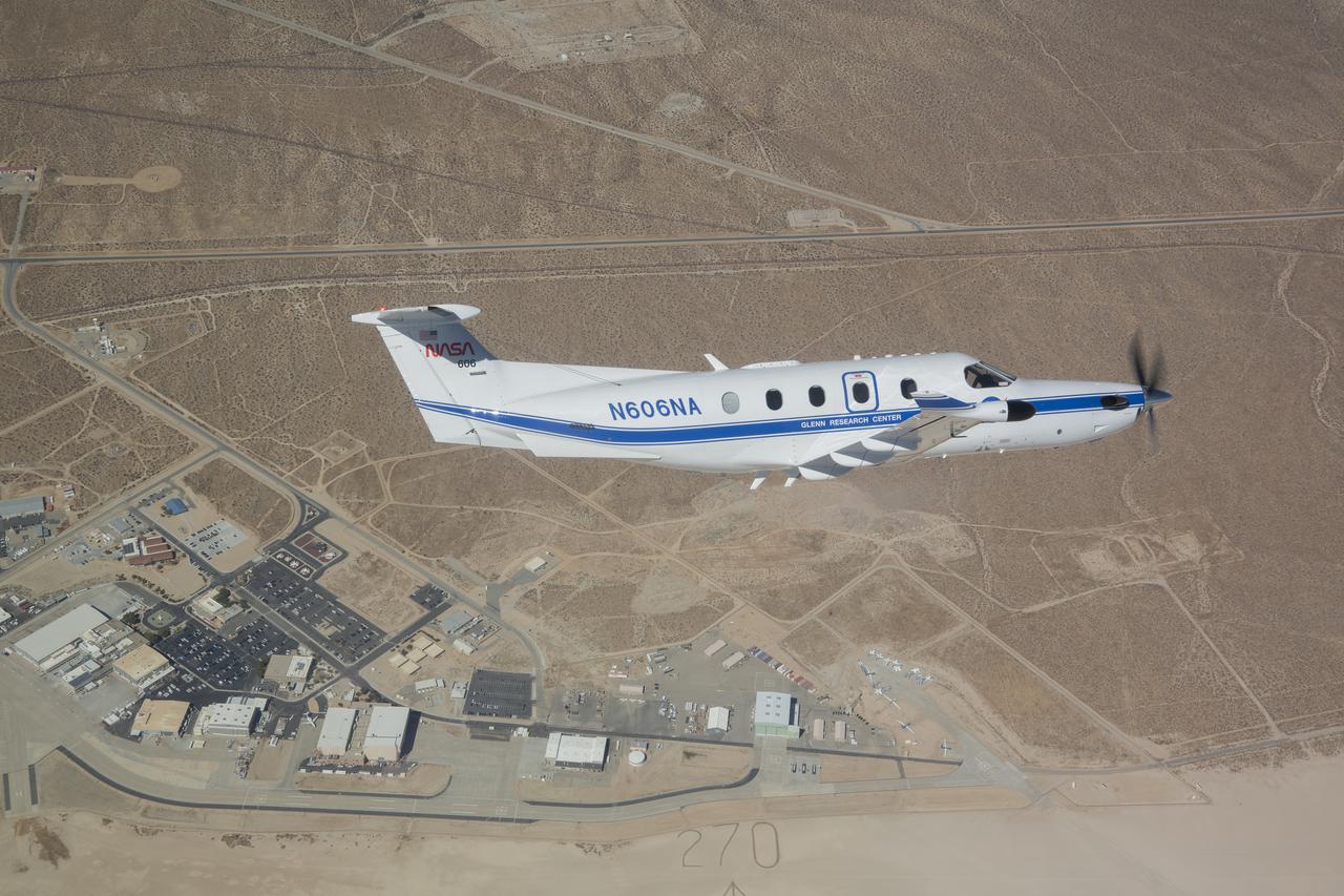 NASA’s Pilatus PC-12, based out of NASA’s Glenn Research Center in Cleveland, is seen flying over NASA’s Armstrong Flight Research Center in Edwards, California. On Sept. 18, 2024, NASA pilots and crew from both centers flew the PC-12 over the Mojave Desert in a series of familiarization flights. Familiarization flights involve egress training, preflight walkaround, interior preflight, engine start, taxi, and takeoff.  
