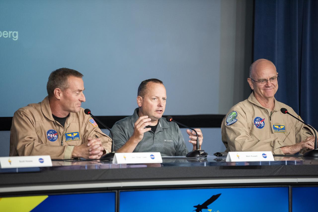 Mark Russell, center, a research pilot at NASA’s Glenn Research Center in Hampton, Virginia, explains the differences in flight environments at different NASA centers. Jim Less, a NASA pilot at NASA’s Armstrong Flight Research Center in Edwards, California, left, Russell, and Nils Larson, NASA Armstrong chief X-59 aircraft pilot and senior advisor on flight research, provided perspective on flight research at the Ideas to Flight Workshop on Sept. 18 at NASA Armstrong.