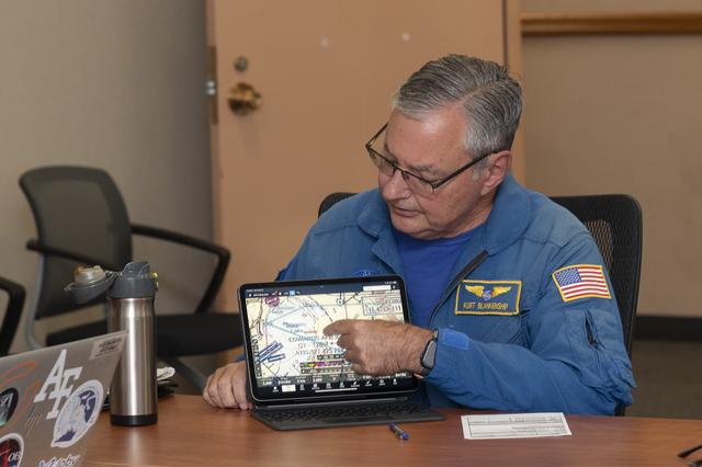 NASA image: NASA pilot Kurt Blankenship reviews flight plans during the pre-flight brief to gather Automatic Dependent Surveillance-Broadcast data using NASA’s Pilatus PC-12 at NASA’s Armstrong Flight Research Center in Edwards, California on Sept. 23, 2024.