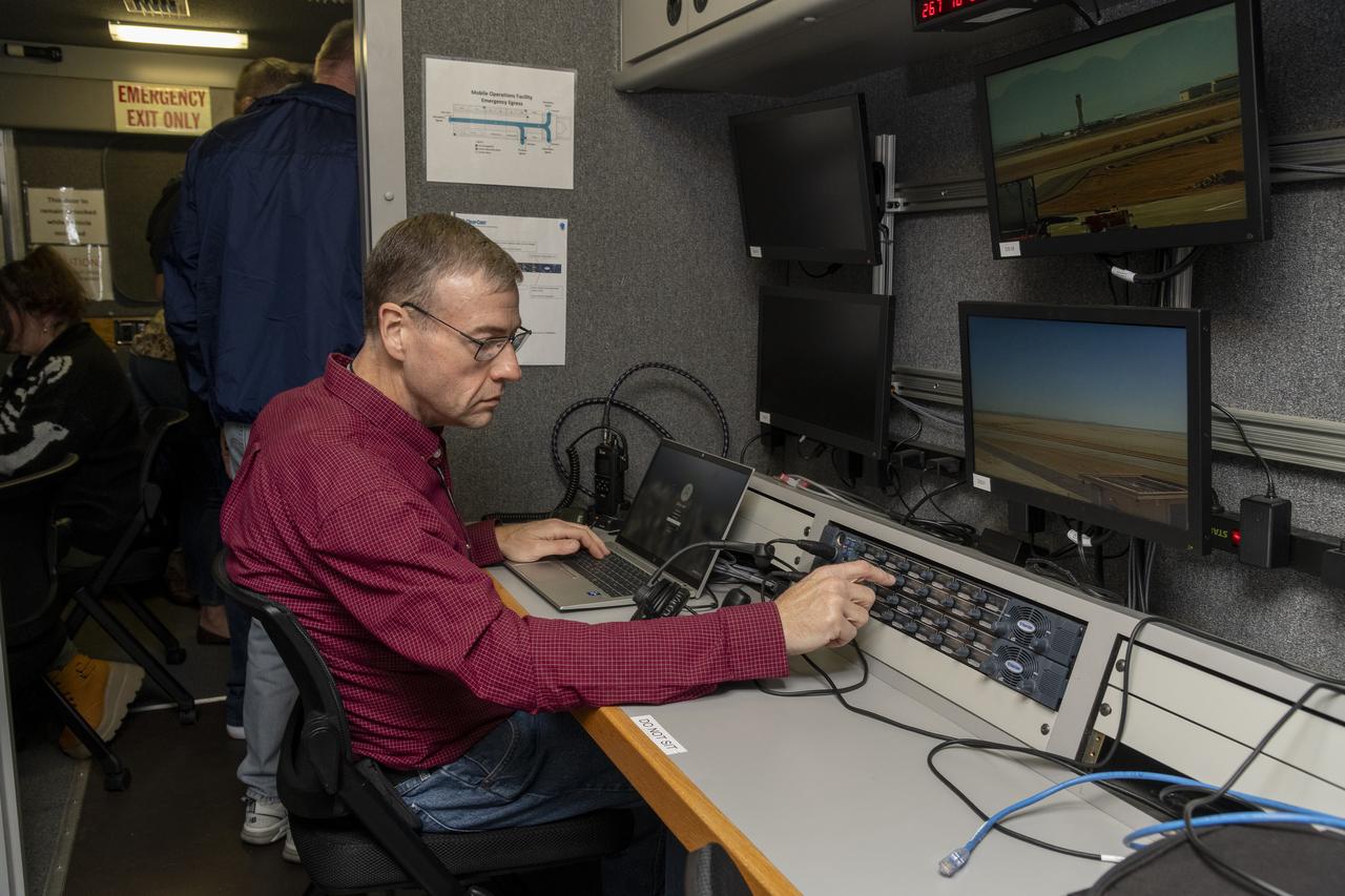 Working in the Mobile Operations Facility at NASA’s Armstrong Flight Research Center in Edwards, California, NASA Advanced Air Mobility researcher Dennis Iannicca adjusts a control board to capture Automatic Dependent Surveillance-Broadcast (ADS-B) data during test flights. The data will be used to understand ADS-B signal loss scenarios for air taxi flights in urban areas.