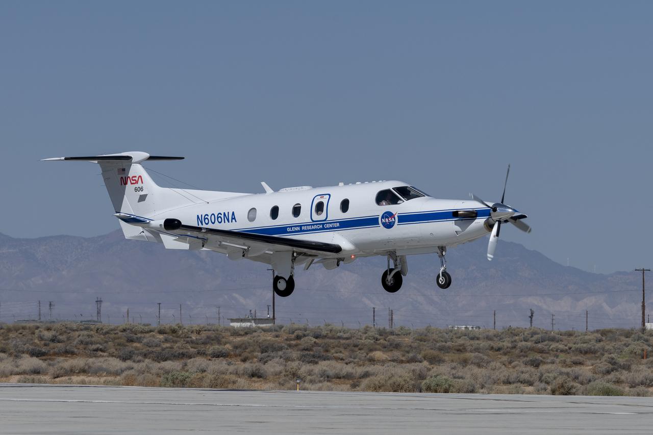 Equipped with state-of-the-art technology to test and evaluate communication, navigation, and surveillance systems NASA’s Pilatus PC-12 performs touch-and-go maneuvers over a runway at NASA’s Armstrong Flight Research Center in Edwards, California on Sept. 23, 2024. Researchers will use the data to understand Automatic Dependent Surveillance-Broadcast (ADS-B) signal loss scenarios for air taxi flights in urban areas. To prepare for ADS-B test flights pilots and crew from NASA Armstrong and NASA’s Glenn Research Center in Cleveland, ran a series of familiarization flights. These flights included several approach and landings, with an emphasis on avionics, medium altitude air-work with steep turns, slow flight and stall demonstrations.