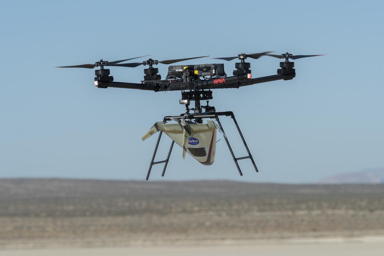 An atmospheric probe model attached upside down to a host quad rotor remotely piloted aircraft lifts off on Oct. 22, 2024. The quad rotor aircraft released the probe above Rogers Dry Lake, a flight area adjacent NASA’s Armstrong Flight Research Center in Edwards, California. The probe was designed and built at the center.