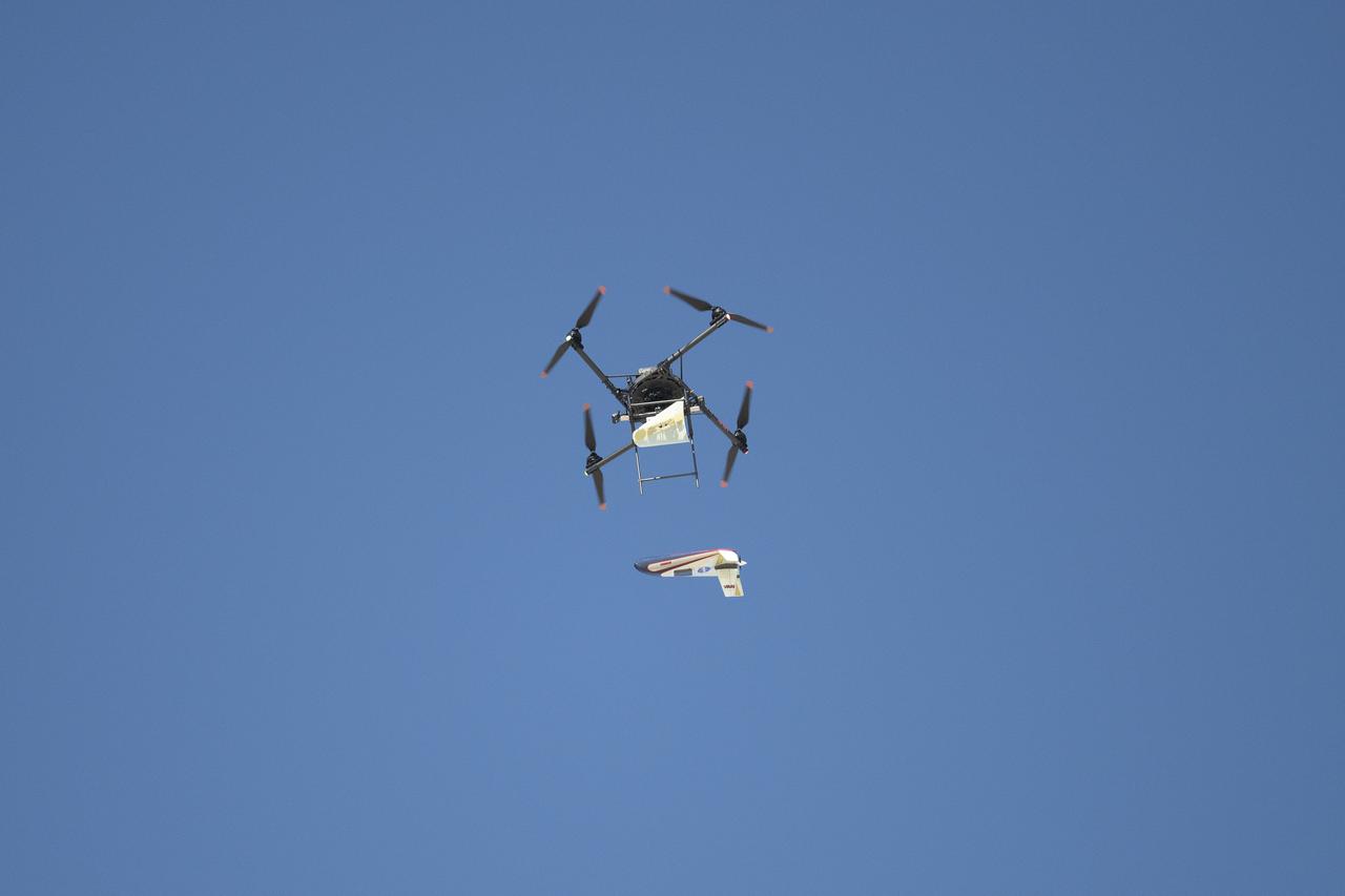 A quad rotor remotely piloted aircraft releases the atmospheric probe model above Rogers Dry Lake, a flight area adjacent NASA’s Armstrong Flight Research Center in Edwards, California, on Oct. 22, 2024. The probe was designed and built at the center.