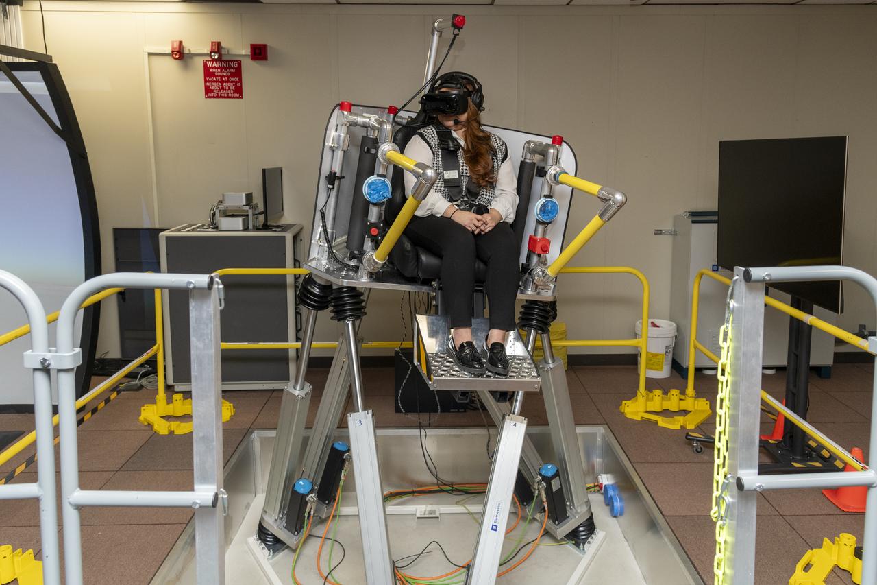 NASA employee Naomi Torres sits inside the air taxi passenger ride quality simulator at NASA’s Armstrong Flight Research Center in Edwards, California, during a study on Oct. 23, 2024. Research continues to better understand how humans may interact with these new types of aircraft.