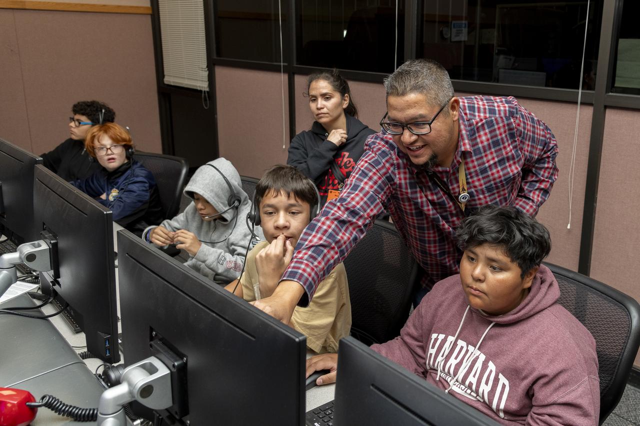 A group of middle school students and their teachers sit in the control room for a hands-on experience at NASA’s Armstrong Flight Research Center in Edwards, California during an event hosted by NASA’s California Office of STEM Engagement for National Aviation History Month.
