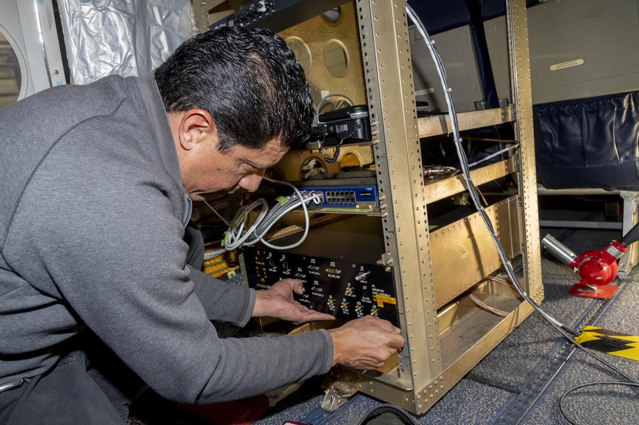 Jose “Manny” Rodriguez adjusts the Soxnav instrument onboard the G-IV aircraft in December 2024. As part of the team of experts, Rodriguez ensures that the electronic components of this instrument are installed efficiently. His expertise will help bring the innovative navigational guidance of the Soxnav system to the G-IV and the wider airborne science fleet at NASA. Precision guidance provided by the Soxnav enables research aircraft like the G-IV to collect more accurate, more reliable Earth science data to scientists on the ground.