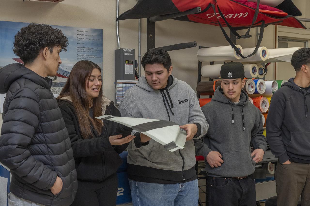 Students look at a subscale model at the Dale Reed Subscale Flight Research Laboratory at NASA’s Armstrong Research Flight Center in Edwards, California. The students are from the engineering club from Palmdale High School in Palmdale, California.