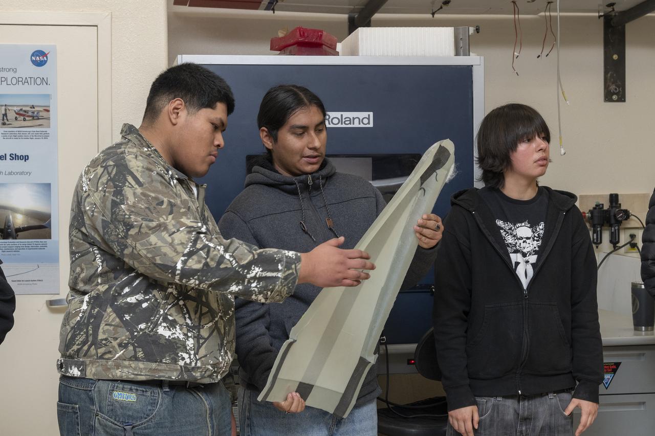 Students look at a subscale model at the Dale Reed Subscale Flight Research Laboratory at NASA’s Armstrong Research Flight Center in Edwards, California. The students are from the engineering club from Palmdale High School in Palmdale, California.