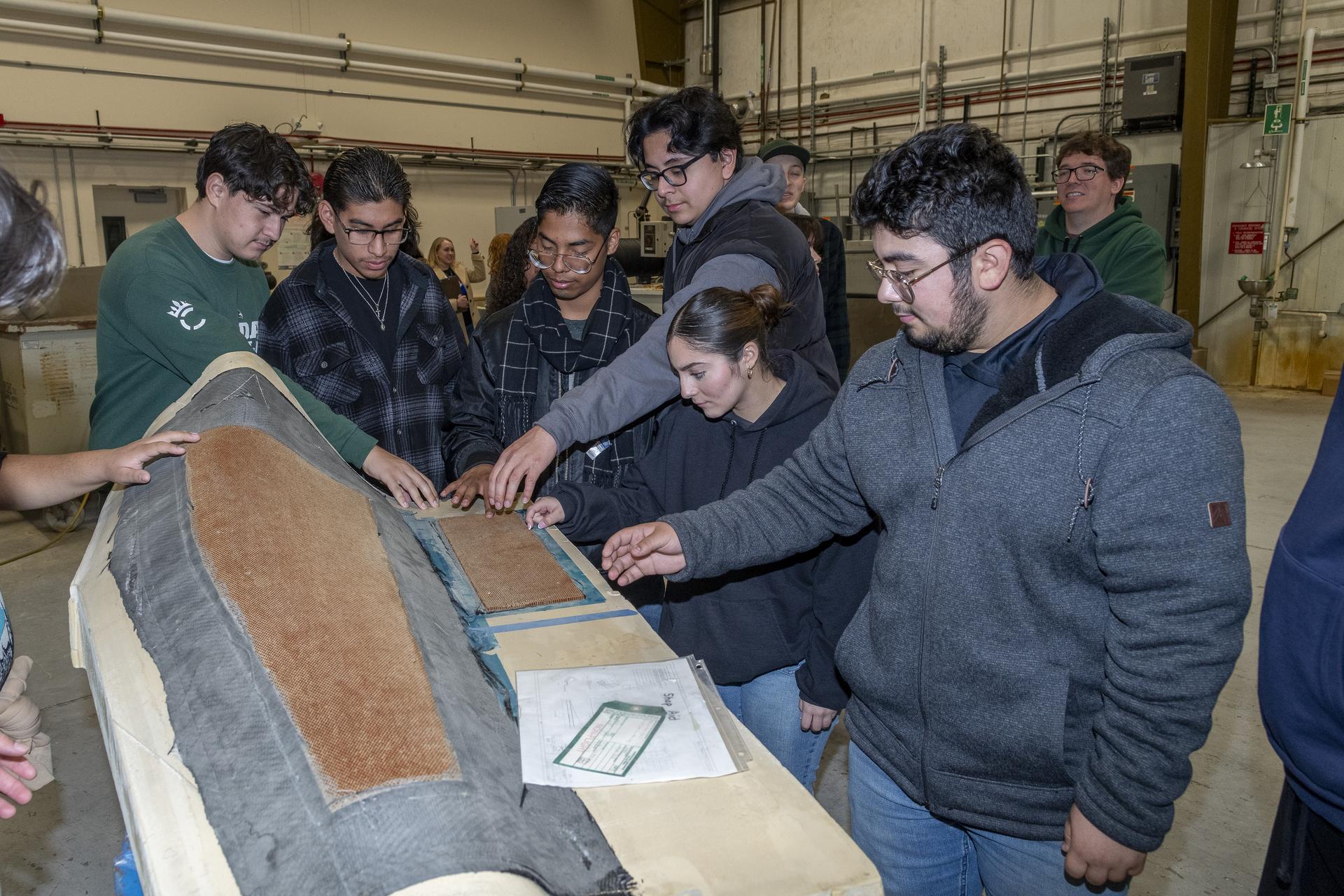 Students are examining a piece of equipment used for testing.
