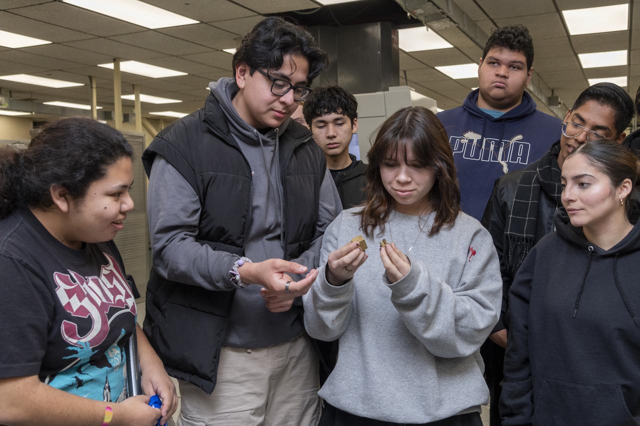 Students examine small parts made at the Experimental Fabrication Shop at NASA’s Armstrong Research Flight Center in Edwards, California. The students are from the engineering club from Palmdale High School in Palmdale, California.
