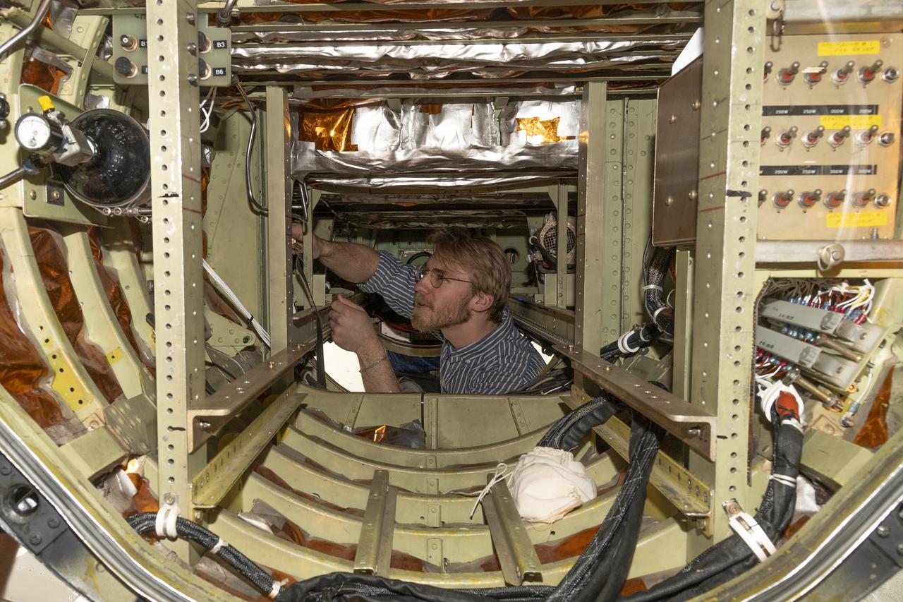 A team of experts prepares the ER-2 aircraft at Armstrong Flight Research Center in Edwards, California for the GSFC Lidar Observation and Validation Experiment (GLOVE) in February 2025. Researcher Jackson Begolka from the University of Iowa examines the instrument connectors in the ER-2 onboard the ER-2, which flies at high altitudes to validate satellite-borne data. As a collaboration between engineers, scientists, and aircraft professionals, GLOVE aims to improve satellite data products for Earth Science applications.