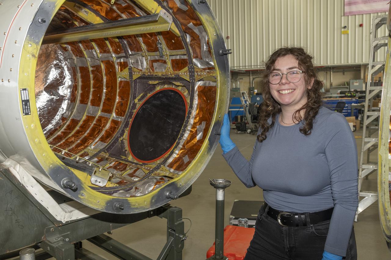 A team of experts prepares the ER-2 aircraft at Armstrong Flight Research Center in Edwards, California for the GSFC Lidar Observation and Validation Experiment (GLOVE) in February 2025. Researcher Jennifer Moore from NASA’s Goddard Space Flight Center smiles beside the ER-2 aircraft’s forebody pod where the Cloud Physics Lidar (CPL) instrument will be installed. As a collaboration between engineers, scientists, and aircraft professionals, GLOVE aims to improve satellite data products for Earth Science applications.