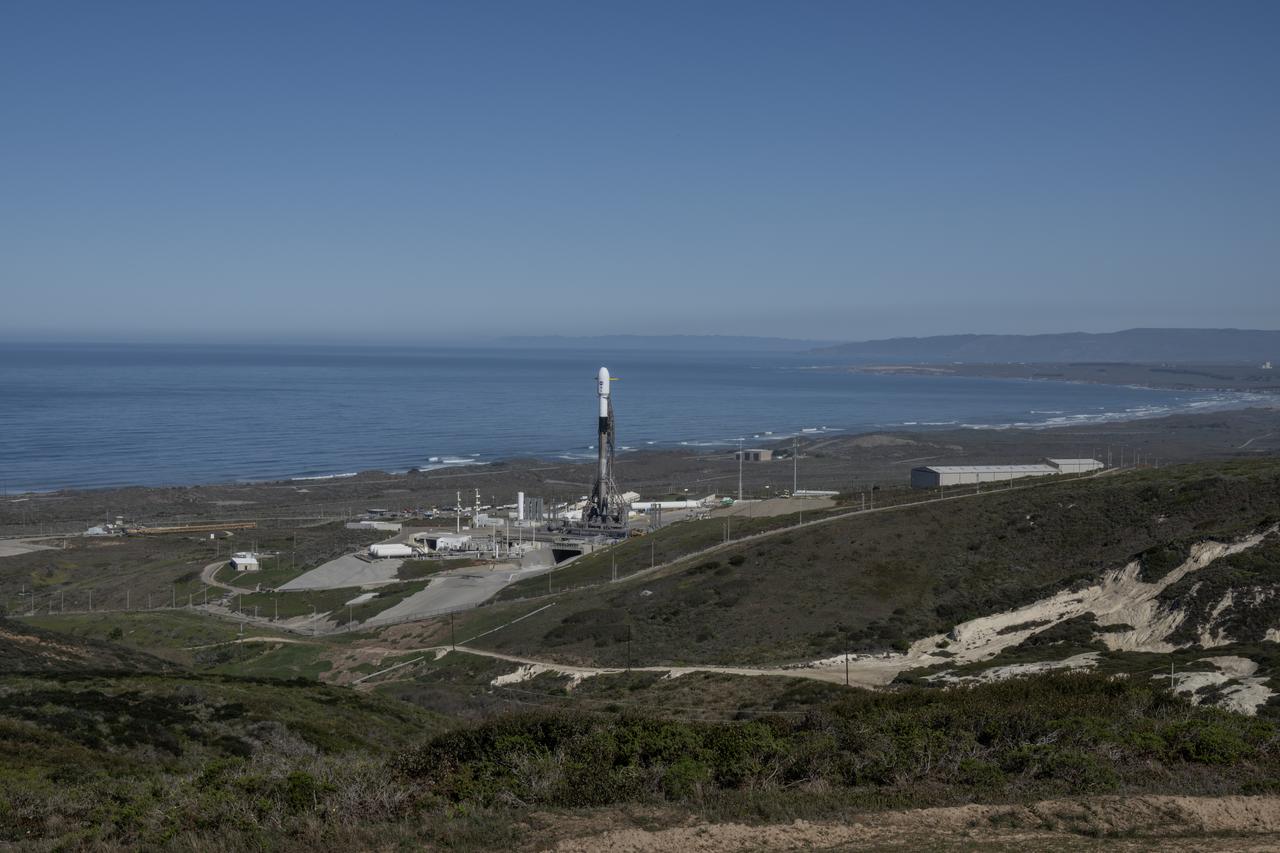 A SpaceX Falcon 9 rocket, carrying NASA’s SPHEREx (Spectro-Photometer for the History of the Universe, Epoch of Reionization and Ices Explorer) observatory and PUNCH (Polarimeter to Unify the Corona and Heliosphere) satellites, is vertical at Space Launch Complex 4 East from Vandenberg Space Force Base in California on Saturday, March 8,  2025. SPHEREx will use its telescope to provide an all-sky spectral survey, creating a 3D map of the entire sky to help scientists investigate the origins of our universe. PUNCH will study origins of the Sun’s outflow of material, or the solar wind, capturing continuous 3D images of the Sun’s corona and the solar wind’s journey into the solar system. 