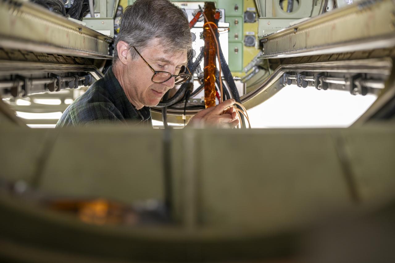 Dr. John Woodward, of the National Institute of Standards and Technology and co-investigator on the airborne Lunar Spectral Irradiance (air-LUSI) mission, prepares the instrument for upload onto the ER-2 aircraft in March 2025 at NASA’s Armstrong Flight Research Center in Edwards, California.