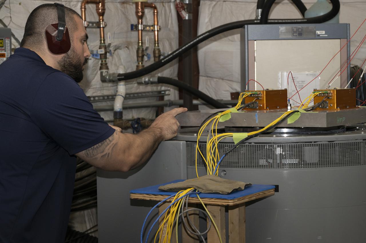 Jonathan Lopez prepares the hypersonic Fiber Optic Sensing System for vibration tests in the Environmental Laboratory at NASA’s Armstrong Flight Research Center in Edwards, California. Testing on a machine called a shaker proved that the system could withstand the severe vibration it will endure in hypersonic flight, or travel at five times the speed of sound.