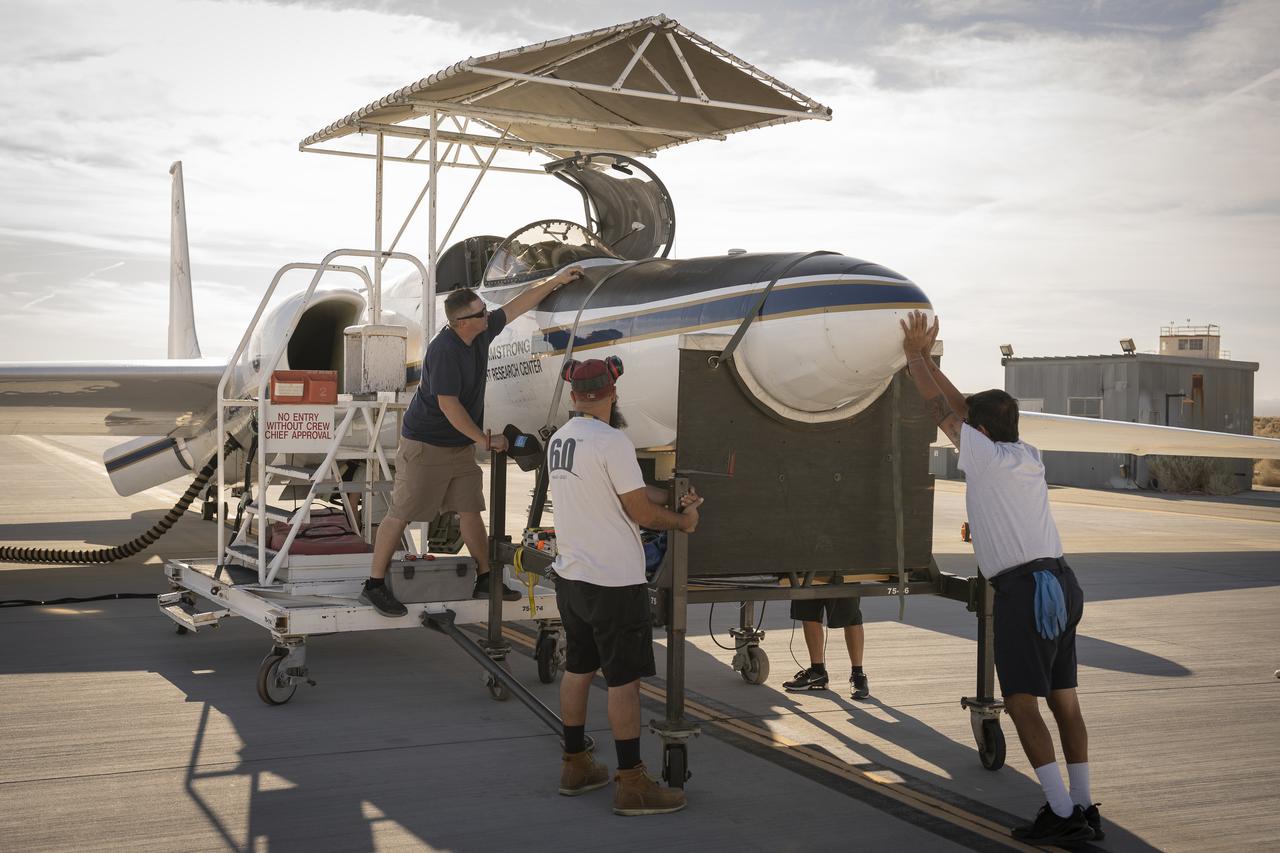 Crew members reattach the nose cone of NASA’s Armstrong Flight Research Center’s ER-2 aircraft at Edwards, California, on Thursday, Aug. 21, 2025, ahead of a mission for the Geological Earth Mapping Experiment (GEMx). The aircraft’s nose houses key science instruments used to collect data during flight.
