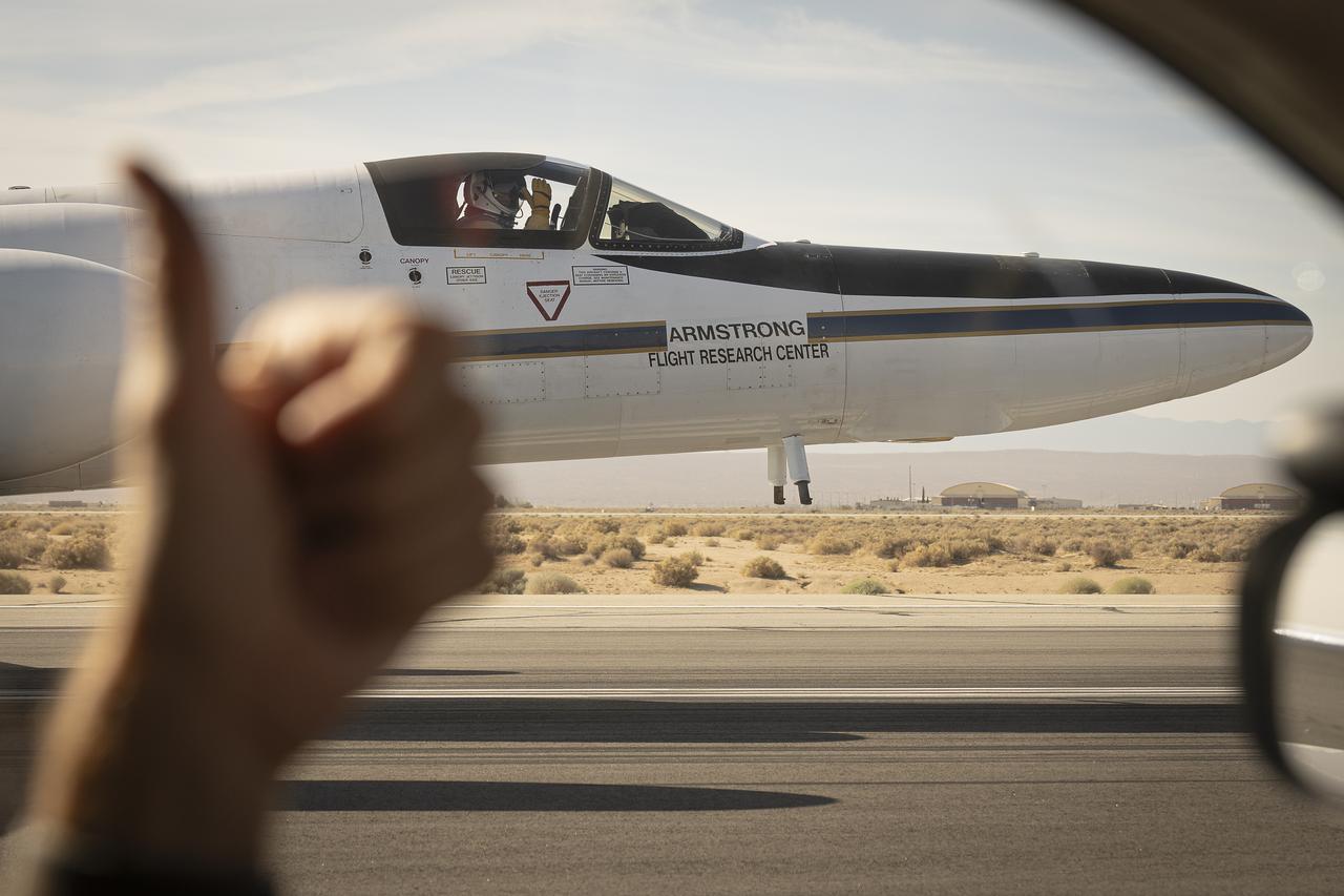 From the window of the ER-2 chase car, a crew member gives a thumbs up to the pilot as NASA Armstrong Flight Research Center’s ER-2 aircraft taxis at Edwards, California, on Thursday, Aug. 21, 2025. The gesture signals a final check before takeoff for the high-altitude mission supporting the Geological Earth Mapping Experiment (GEMx).