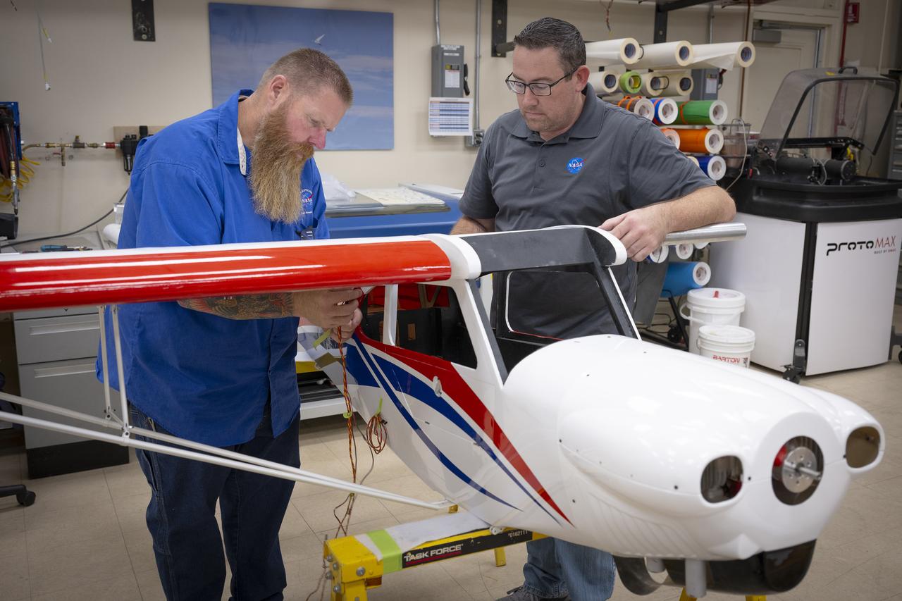 Justin Hall, left, and Justin Link secure a wing onto a subscale aircraft on Wednesday, Sept. 3, 2025, at NASA’s Armstong Flight Research Center in Edwards, California. Hall is chief pilot at the center’s Dale Reed Subscale Flight Research Laboratory and Link is a pilot for small uncrewed aircraft systems.