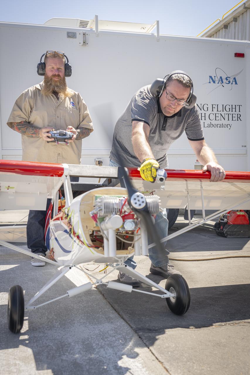 Justin Hall, left, controls a subscale aircraft as Justin Link holds the aircraft in place during preliminary engine tests on Friday, Sept. 12, 2025, at NASA’s Armstong Flight Research Center in Edwards, California. Hall is chief pilot at the center’s Dale Reed Subscale Flight Research Laboratory and Link is a pilot for small uncrewed aircraft systems.