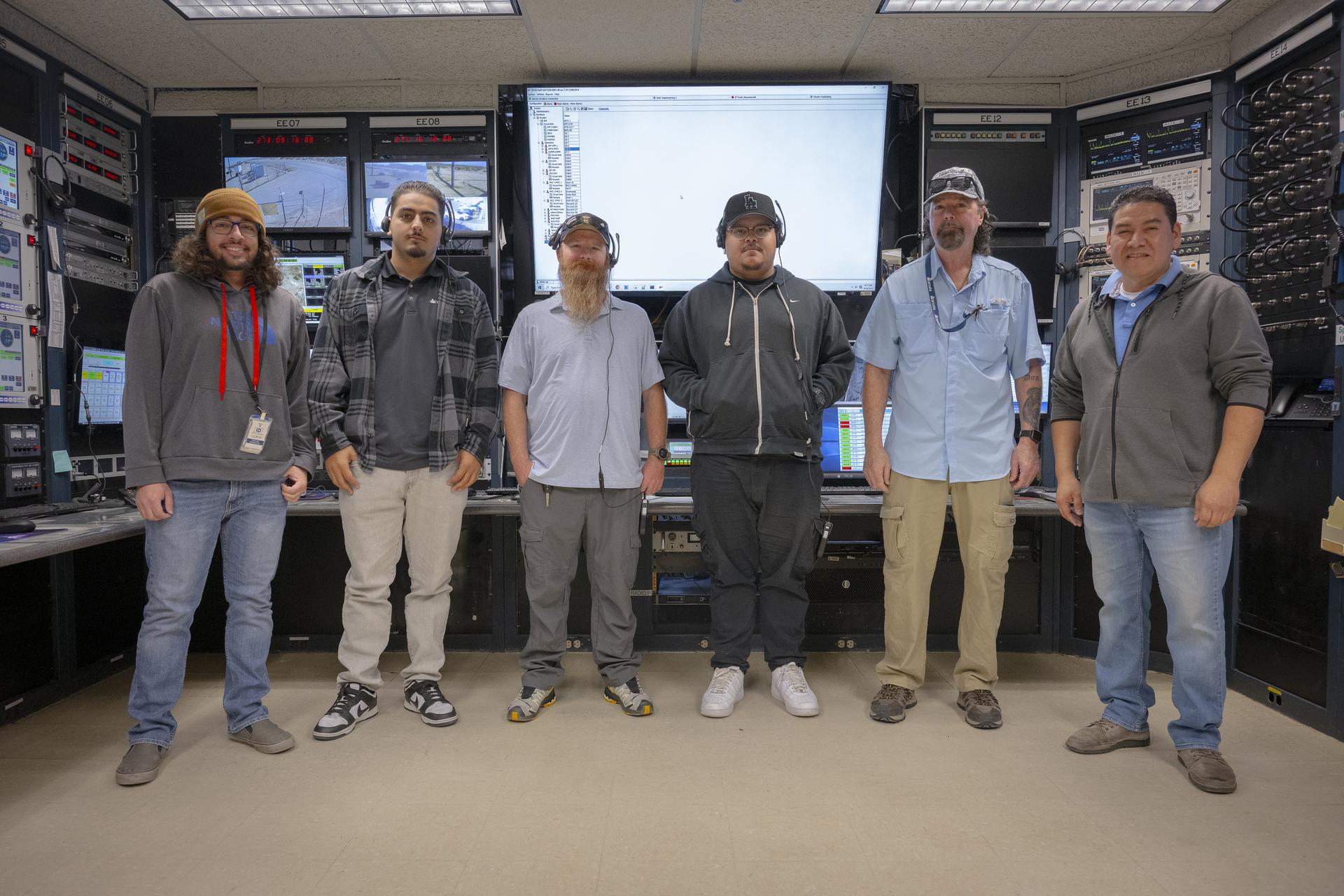 Mission technicians, from left, Adam Cataldo, Alex Oganesyan, Daniel Kelly, Deming Ingles, Mike Gibson, and Kelvin Menendez support communications backup for an International Space Station mission on Tuesday, Sept. 30, 2025, at NASA’s Armstong Flight Research Center in Edwards, California. The team is part of the center’s Dryden Aeronautical Test Range, which provides voice and tracking support to the space station.