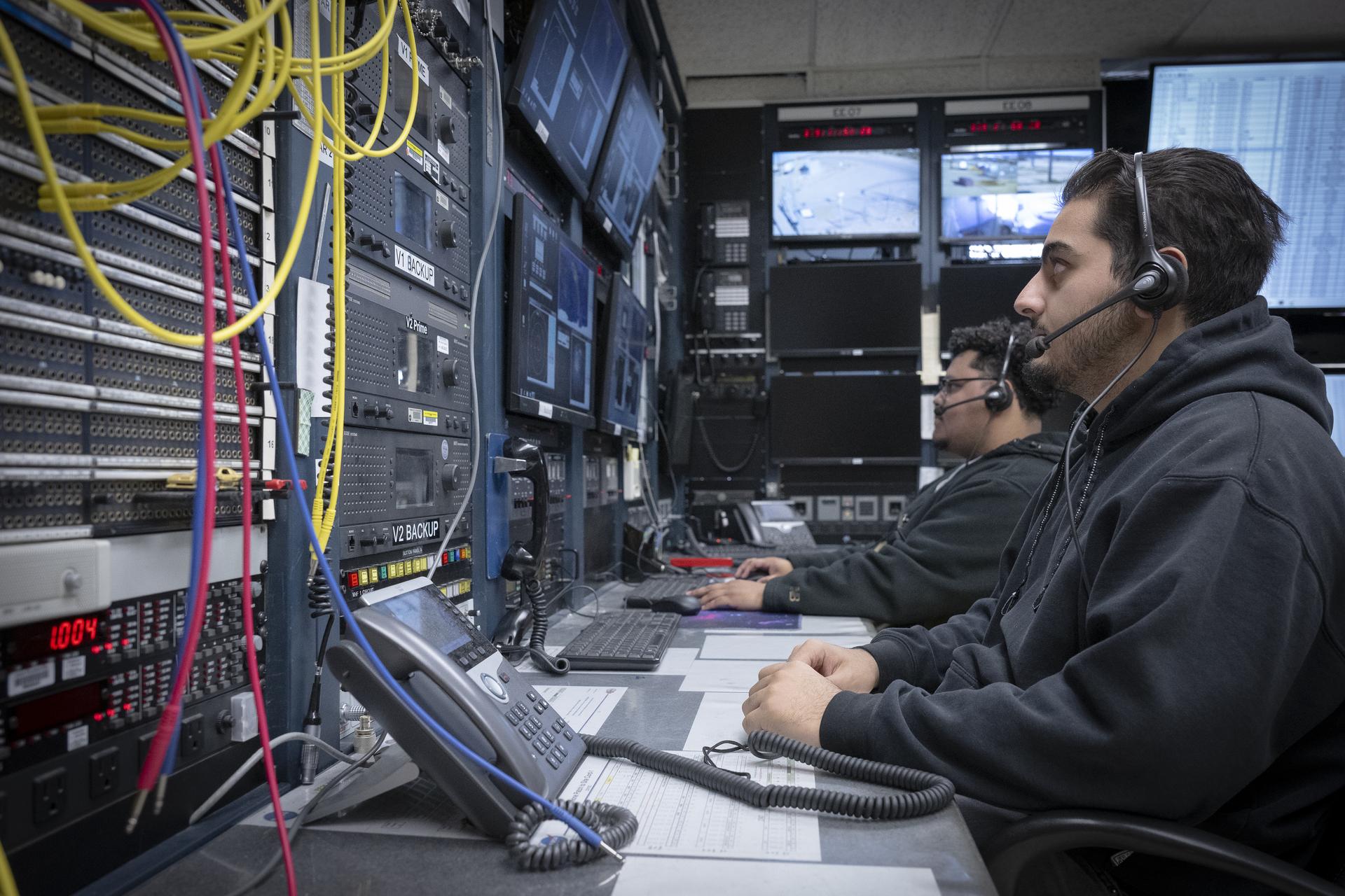 Range operators at the Dryden Aeronautical Test Range at NASA’s Armstong Flight Research Center in Edwards, California, provide voice and tracking support to the International Space Station. In this Friday, Dec. 6, 2025, photo, Alex Oganesyan, left, and Deming Ingles are shown at their workstations, where they support communications backup for space station missions.