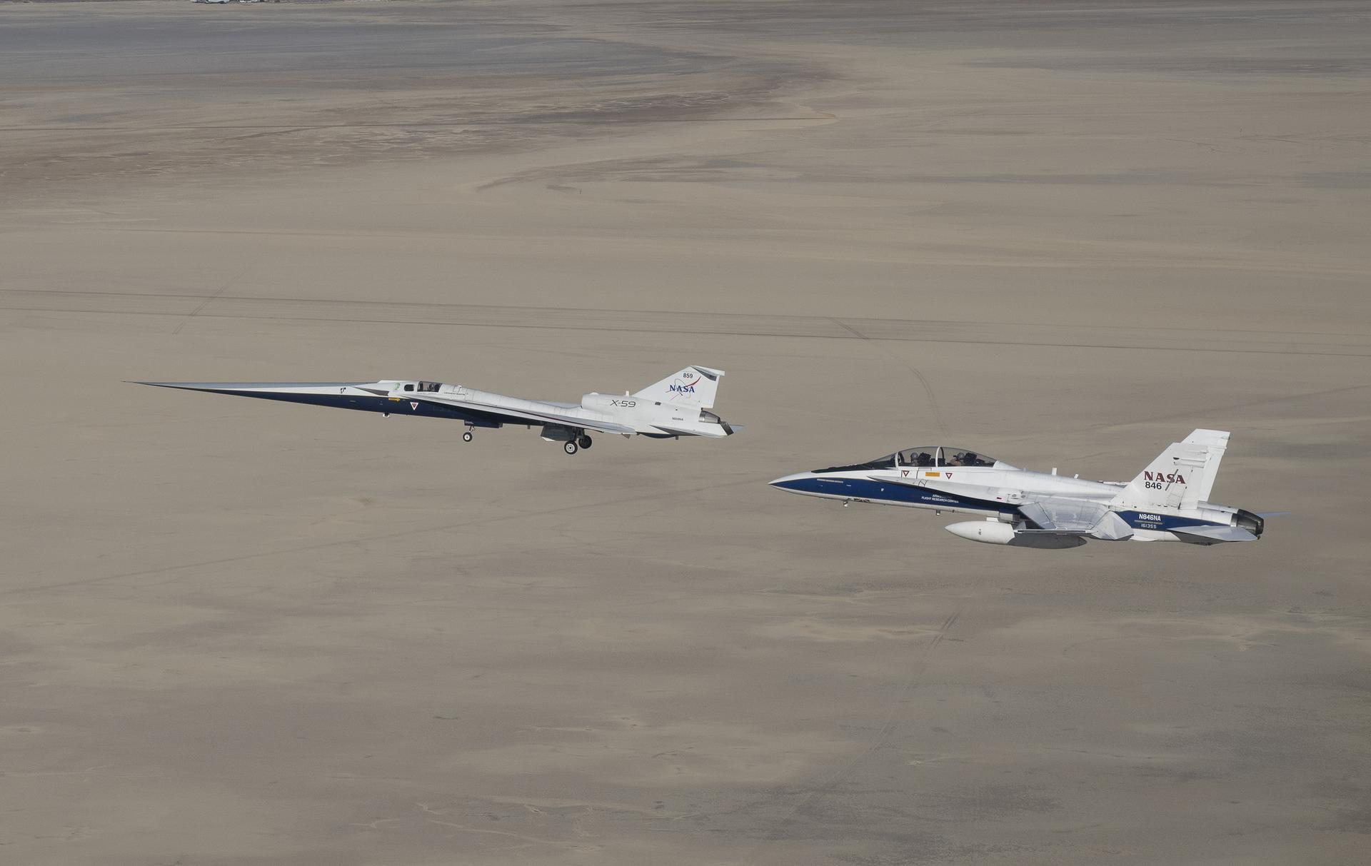 NASA’s X-59 quiet supersonic research aircraft flies above Palmdale and Edwards, California, during its first flight Tuesday, Oct. 28, 2025, accompanied by a NASA F/A-18 research aircraft. A NASA F-15 research aircraft (not pictured) captured the image as the X-59 traveled to NASA’s Armstrong Flight Research Center in Edwards, California, where it will begin flight testing for NASA’s Quesst mission, which aims to demonstrate quiet supersonic flight over land.